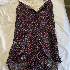 Button-up romper with little rose pattern and a sweater material laced back.